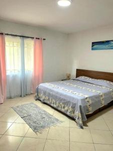 a bedroom with a bed with a blue comforter at 3 bedroom Ground Floor beach Flic en Flac in Flic-en-Flac