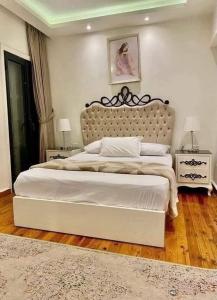 a bedroom with a large bed and two night stands at القرية الذكيةبريتال فيو اكوا بارك in El Alamein