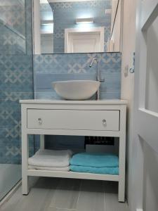 a bathroom vanity with a sink and a mirror at Casa Tiemme Vista Mare in Costa Paradiso