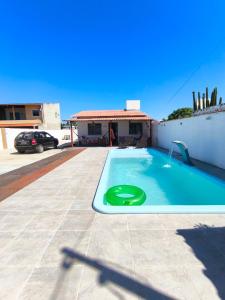 a swimming pool with a green frisbee in it at Casa de Praia Em Aracaju,Se in Barra dos Coqueiros