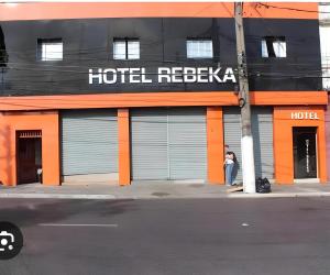 a person standing outside of a hotel reissue at Hotel rebeka in São Paulo