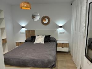 a bedroom with a bed and two night stands at Del Carmen in Vinarós
