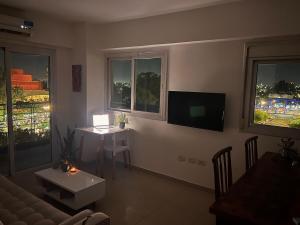 a living room with a couch and a table and two windows at Andean Viewpoint in San Juan