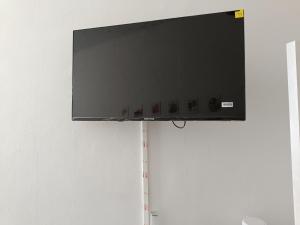 a flat screen tv hanging on a wall at Chez Oppo in Charleroi