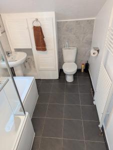 a bathroom with a toilet and a sink at LEB Homes UK, 3 Bedroom House - 2 mins walk to station in Crawley +31 photos