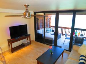 a living room with a couch and a flat screen tv at 2BR Luxury Beachfront Duplex Villa on Sapphire Beach III in East End