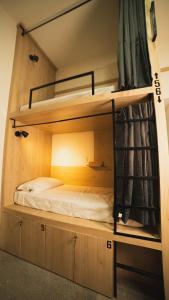a bunk bed in a room with a bed in it at A Hostel in Guadalajara +8 photos