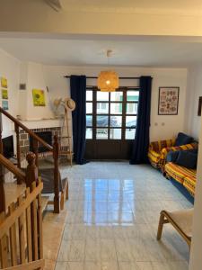 a living room with a couch and a window at Seashell Consolação in Atouguia da Baleia