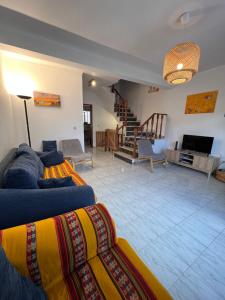 a living room with a couch and a tv in a room at Seashell Consolação in Atouguia da Baleia