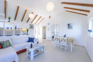 a living room with a couch and a table at Apartment Island Oasis in Koločep