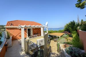 a house with a balcony with a view of the ocean at Apartment Island Oasis in Koločep