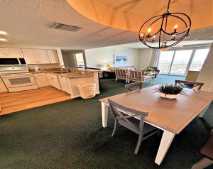 a kitchen and living room with a table and chairs at Wyndham Ocean Walk Resort - Vacation in Comfort by the sea - 2BR Oceanview 24320 in Daytona Beach