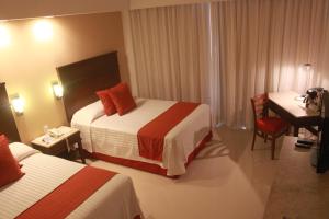 Postel nebo postele na pokoji v ubytování Hotel Bello Veracruz