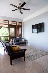 a living room with a ceiling fan and a couch at Hidden Secret in Gros Islet