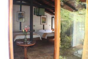 A bed or beds in a room at Bosque Protector Hacienda Guamag