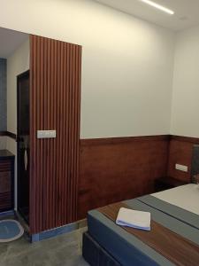 a bedroom with a bed and a wooden door at The Tree House in Vythiri