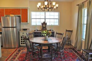 a kitchen with a table and chairs and a refrigerator at Inn at Indian Creek in Burton