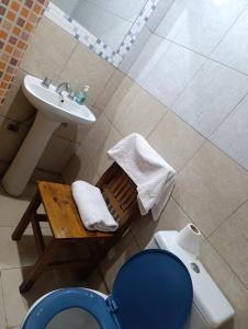 a bathroom with a sink and a toilet at Alojamiento walter in Ezeiza +5 photos