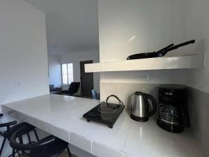 a kitchen with a counter with a coffee maker and a blender at Casa Yaxche 1 in Izamal