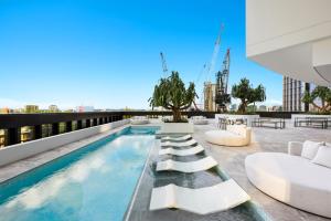 a swimming pool on the roof of a building at Brisbane 1BR with Pool, Spa, Sauna and Balcony in Brisbane