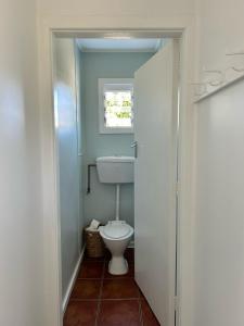 a bathroom with a toilet and a sink at Spacious, Sunny and Warm Home in Kaikoura in Kaikoura