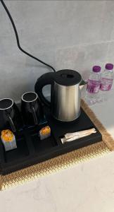 a black tray with a tea kettle and some sushi at Quite Studio in Abha