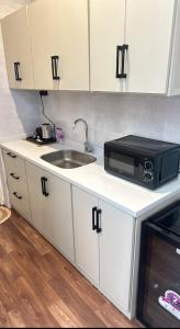 a kitchen with a sink and a microwave at Quite Studio in Abha +5 photos