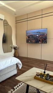 a bedroom with a bed and a tv on the wall at Quite Studio in Abha
