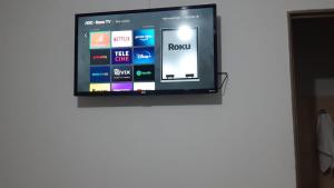 a television on a white wall in a room at Hotel Stillus in Ribas do Rio Pardo