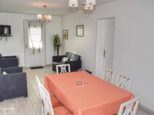 a dining room with an orange table and chairs at Gîte familial avec piscine chauffée et jardin privatif près des châteaux de la Loire - FR-1-381-393 in Luynes