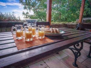 a wooden table with glasses of juice and a plate of bread at Holiday Home Danilo in Sveti Stefan