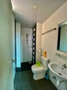 a bathroom with a toilet and a sink at SK Holiday Apartment in Tanah Rata