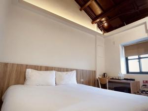 Voodi või voodid majutusasutuse 貝富門旅館 - 澎湖灣行旅 toas