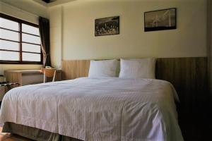 Voodi või voodid majutusasutuse 貝富門旅館 - 澎湖灣行旅 toas