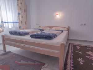 a bedroom with two beds in a room with a rug at Holiday Home Danilo in Sveti Stefan