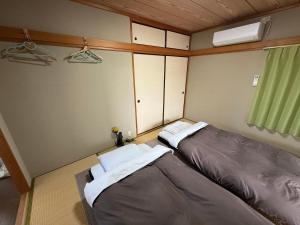 Postel nebo postele na pokoji v ubytování 民泊中村邸