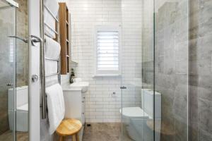 a bathroom with a toilet and a glass shower at Balmoral beauty - Elevated living on the esplanade BALO1 in Sydney