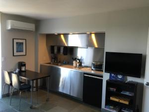 a kitchen with a table and a counter top at Silver Box Beverly Hills in Los Angeles