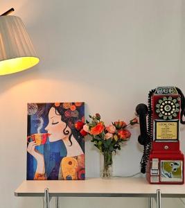 a table with a picture of a woman drinking coffee and a phone at Suwon Hwaseong 507, the happiest trip of my life Love Stay in Suwon