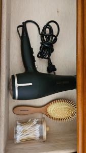 a shelf with a hair dryer and a hair brush at Suwon Hwaseong 507, the happiest trip of my life Love Stay in Suwon