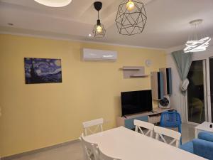 a living room with a white table and chairs at Peaceful Challette Two Bedrooms in Murano El Sokhna in Ain Sokhna