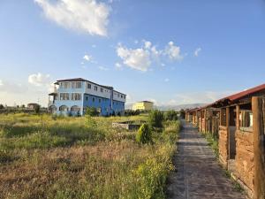a blue building in the middle of a field at Parasut Village Hotel in Kargakonmaz