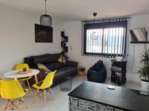 a living room with a couch and a table and chairs at Attic terrace 360 Moncofa in Moncófar