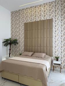 a bedroom with a large bed with a padded headboard at Casa de praia, mangaratiba sahy in Mangaratiba +49 photos