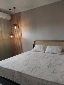 a bedroom with a bed with two pillows on it at Kenka Homestay in Jetis +48 photos