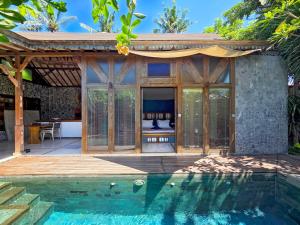 a guest house with a pool in front of it at Samsara Villas in Gili Islands