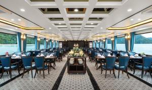 a dining car on a train with tables and chairs at Quynh Yen Hotel in Ha Long