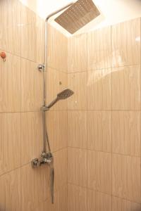 a shower with a shower head in a bathroom at Executive 2 Bedroom RealShala East Legon Hills in Maijaw +51 photos