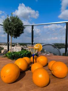 a bunch of oranges sitting on a table with a drink at Rovno Hotel in Vidin