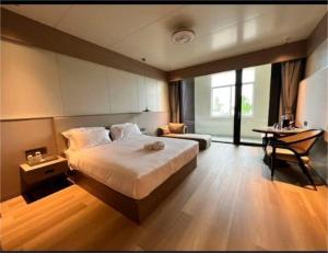a large bedroom with a large bed and a desk at Grace Hotel in Honiara